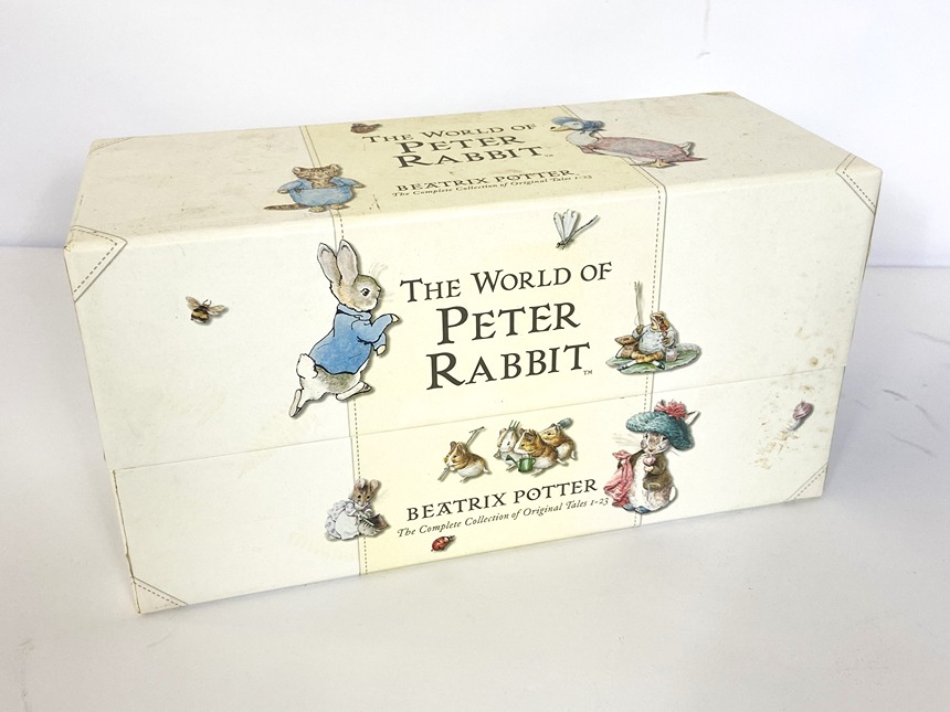A large assortment of books and games, including The World of Peter Rabbit, a boxed set; also