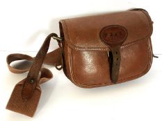 Two leather cartridge bags; with three shotgun cartridge belts; two gun slips; also a large