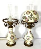 A pair of Victorian style decorative oil lamps, each with a baluster base, decorated with panels