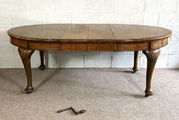 A Georgian style mahogany extending oval dining table, 20th century, with moulded oval top, two