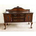 A Georgian style mahogany sideboard, 20th century, with flatware drawers and flanked by cabinets, on