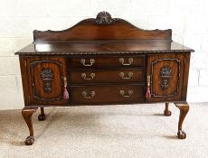 A Georgian style mahogany sideboard, 20th century, with flatware drawers and flanked by cabinets, on