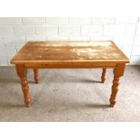 A varnished pine kitchen table, 20th century, with rectangular top and four turned legs