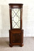 A George III style floor standing corner cabinet, with a glazed display case over a panelled cabinet
