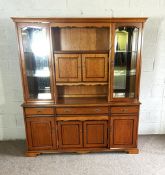 A modern veneered ash china cabinet, with two glazed cabinet doors, niches and arrangement of