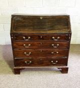 A provincial George III mahogany bureau, with a fall front opening to a fitted interior of pigeon