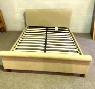 A modern upholstered double bedstead, with padded back in beige fabric, with sprung slatted base,