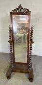 A Victorian mahogany cheval mirror, mid 19th century, the tall rectangular bevelled plate in a frame