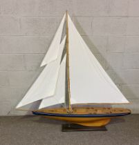 A good and large scale model of a clinker built sailing yacht, fully rigged with four cloth sails,