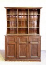 A large vintage bookcase, with twelve compartments, over a base with three cabinets which open to