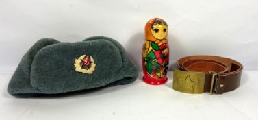 A Soviet USSR era hat and Red Star cap badge; together with a USSR brass belt buckle, etc (a lot)