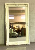 A large wall mirror, with rectangular bevelled plate, in a Victorian composition frame, later