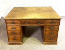 A late Victorian oak partners desk, with a deep plan oak top, one side with three drawers over