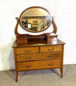 An Edwardian Dressing chest with mirror; together with an associated double bed, with arched