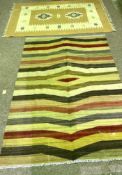 Five assorted rugs, including a modern striped cotton rug, a beige and cream rug, a Chinese style