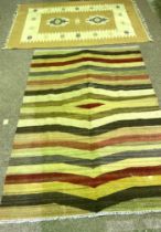 Five assorted rugs, including a modern striped cotton rug, a beige and cream rug, a Chinese style