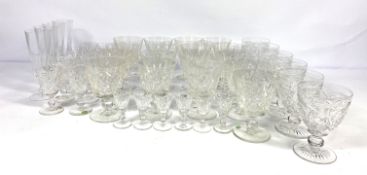 A large assortment of table glassware, including a table lamp base, decanter; a selection of