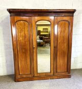 A good Victorian mahogany three door compactum wardrobe, with a mirrored central door, opening to