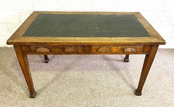 A vintage oak writing table, with ‘leather’ inset top, set on four tapered legs, 80cm high, 140cm
