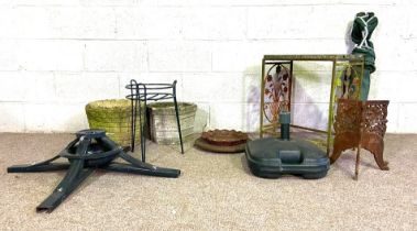 A small group of garden ephemera, including a stone topped table, two planters, a folding chair, a
