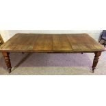 A Victorian mahogany extending dining table, late 19th century, with four fluted and tapered legs,