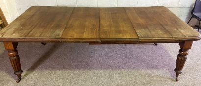 A Victorian mahogany extending dining table, late 19th century, with four fluted and tapered legs,