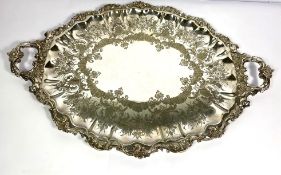 A large silver plated tea tray, early 20th century, with foliate and floral border, 72cm long and