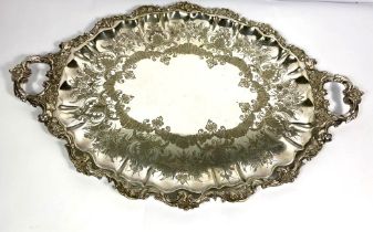A large silver plated tea tray, early 20th century, with foliate and floral border, 72cm long and