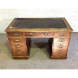 A late Victorian oak desk, with rectangular top over arrangement of nine drawers, 76cm high, 122m