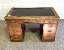A late Victorian oak desk, with rectangular top over arrangement of nine drawers, 76cm high, 122m