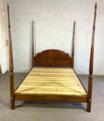 A vintage four poster bed, with an arched panelled headboard, and four tapered turned posts, 220cm