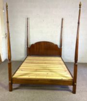 A vintage four poster bed, with an arched panelled headboard, and four tapered turned posts, 220cm