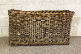 A large and narrow vintage wicker basket, 105cm wide and 60 cm high