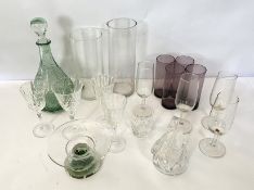 Assorted glassware, including a green glass decanter with stopper, various wine goblets, and gilt