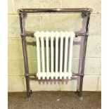 A modern chrome and cast iron radiator towel rail (purchased for home improvement but not