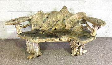 A rustic garden bench, formed from assorted sections of random tree rounds, with two arms, 155cm