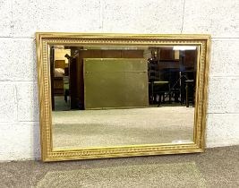 A large modern gilt framed wall mirror, with dentil moulding and bevelled plate