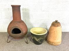 A terracotta garden Chiminea, with stand, 80cm high (plus stand); A vintage terracotta Rhubarb