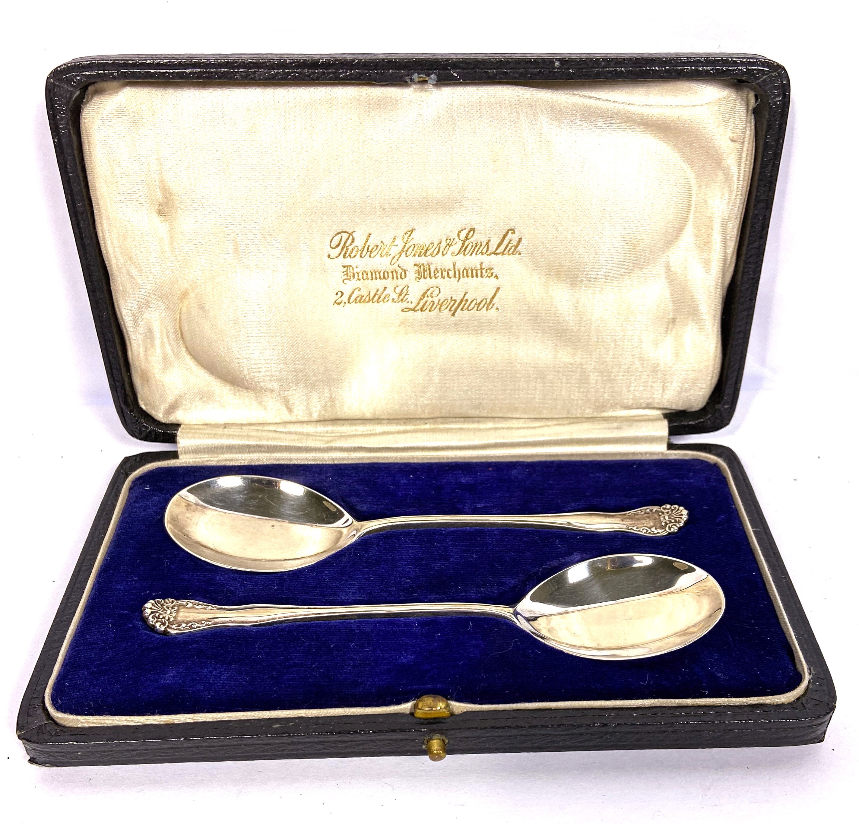 Three cased sets of silver spoons, including a pair of preserve spoons, cased; and two sets of six