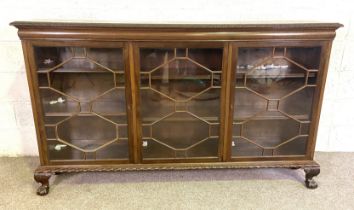 A large George III style mahogany dwarf bookcase, with three glazed doors opening to adjustable