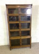 A Globe Wernicke style oak sectional bookcase, with five stories, 173cm high; and another similar