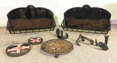 Two iron planters/ hay holders, with three bootmakers irons, a trivet and two trolley wheels (8)