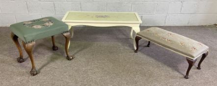 A small white painted coffee table; together with two upholstered tapestry foot stools (3)