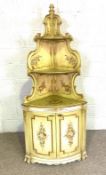 A French Louis XVI style painted corner cabinet, 20th century, with shaped open shelves over a bow