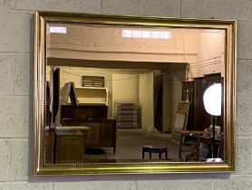 A modern gilt framed wall mirror, with beaded decorative mouldings