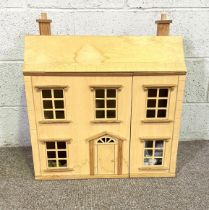 A vintage wood dolls house, in Classical Georgian style, opening to three floors. Available for