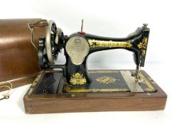 A vintage cased Singer sewing machine; also a paraffin lantern (2)