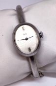 A continental silver Obrey of Paris ladies dress watch, with oval case set on a plain articulated