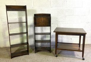 Two small narrow oak book stands, one with a moulded frieze and four shelves, 118cm high; also a