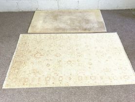 A modern small cream slightly patterned rug; together with another smaller rug (2)